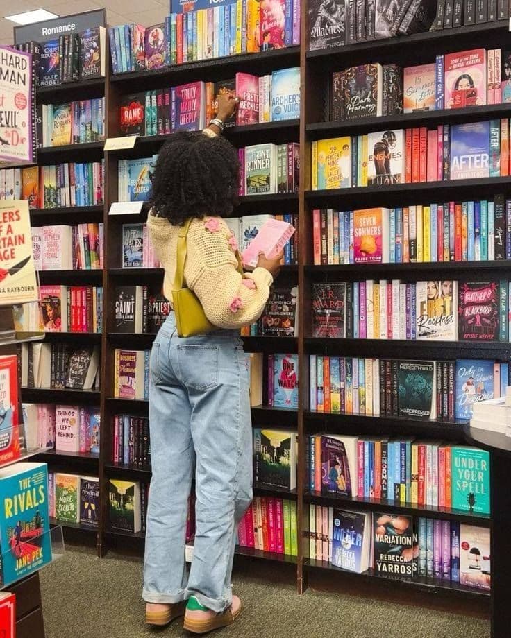 Reader browsing books in a colorful bookstore